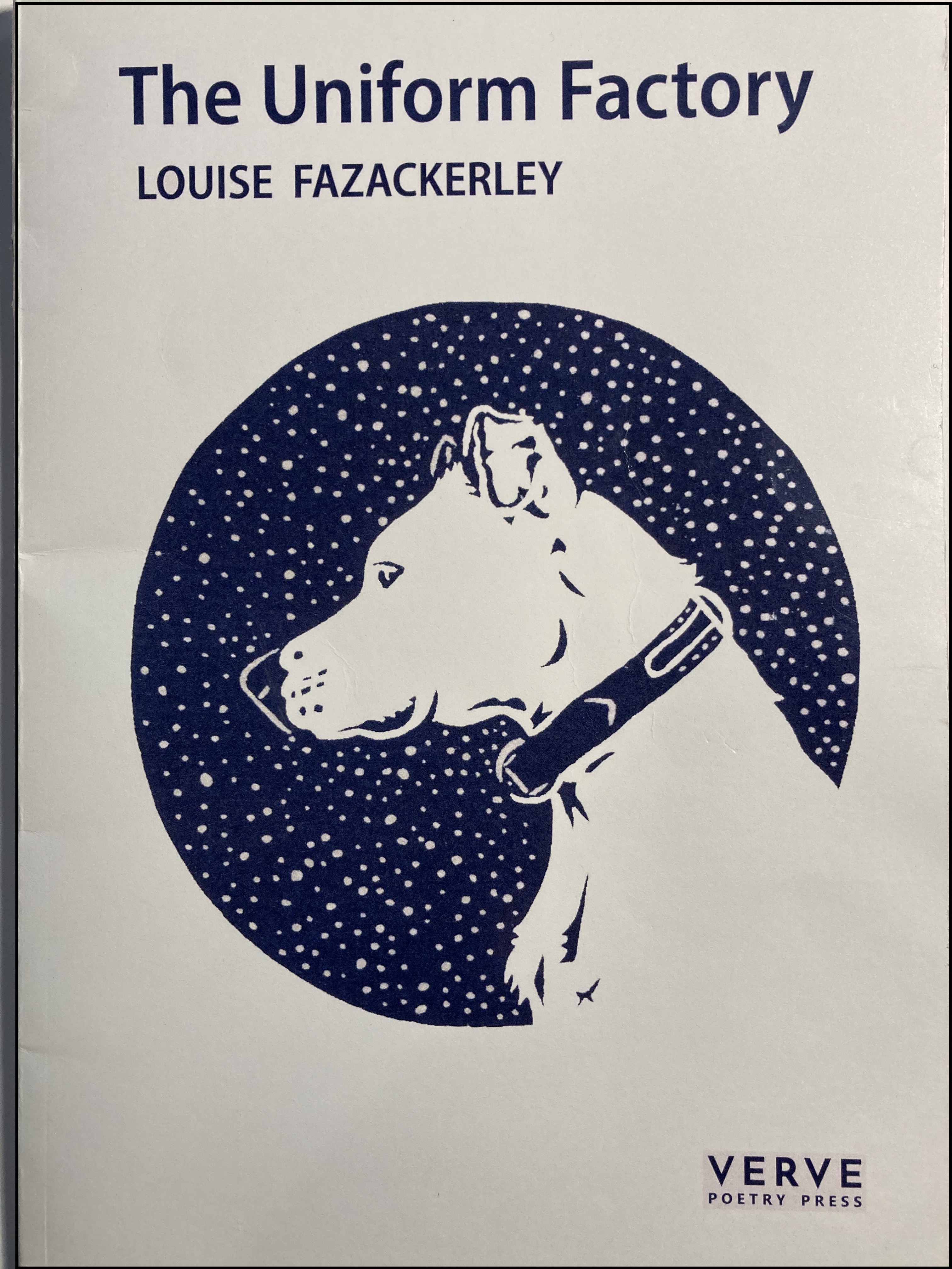 Pale cover with blue lettering and central image: a blue circle with a white dog and spots like snow